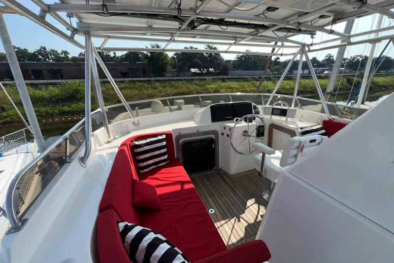 Slide: The Image of Luxurious 2002 Nordhavn 50 yacht cockpit with red seating and modern helm. - 23