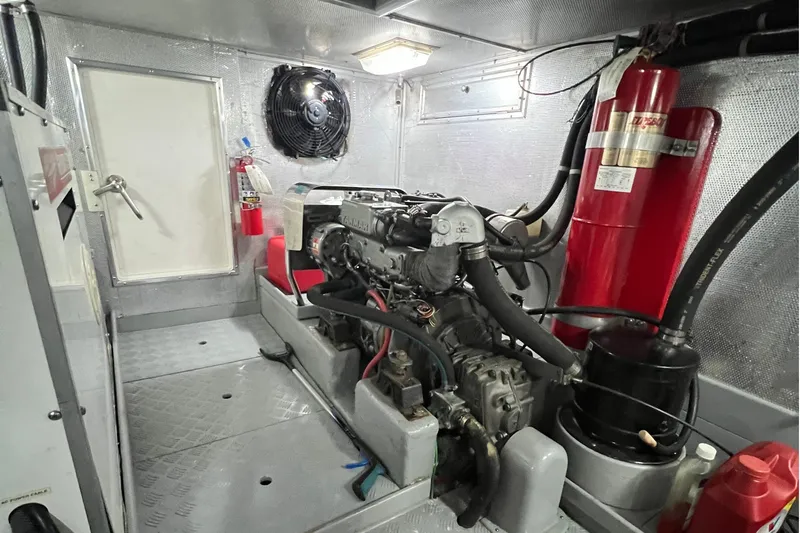 Slide: The Image of Engine room of a 2002 Nordhavn 50 yacht, featuring a Yanmar engine and safety equipment. - 27