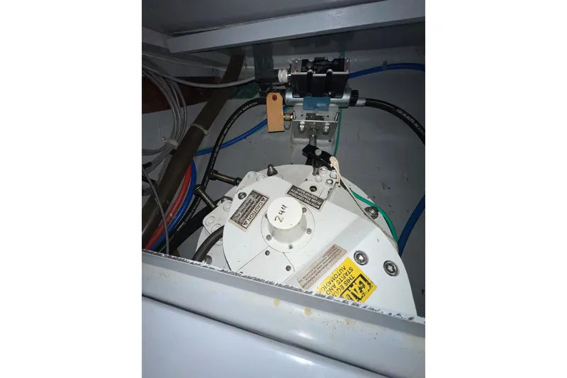 Slide: The Image of Engine compartment of a 2002 Nordhavn 50 yacht, showcasing mechanical components and wiring. - 28