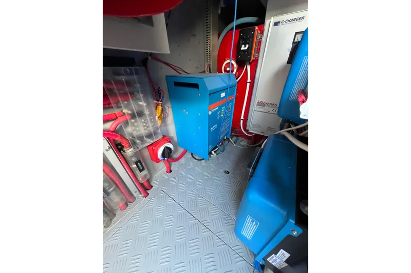 Slide: The Image of Electrical system in a 2002 Nordhavn 50 yacht engine room with blue and red components. - 29