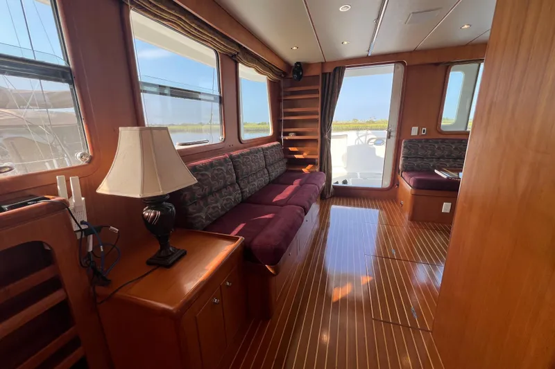 Slide: The Image of Luxurious 2002 Nordhavn 50 yacht interior with elegant wood finishes and plush seating. - 4