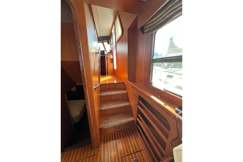 Slide: The Image of Interior of 2002 Nordhavn 50 yacht with wooden stairs and window view. - 5