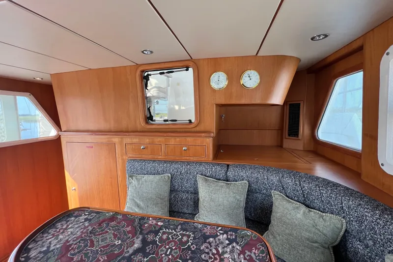 Slide: The Image of Interior of 2002 Nordhavn 50 yacht with wood paneling and cushioned seating area. - 8