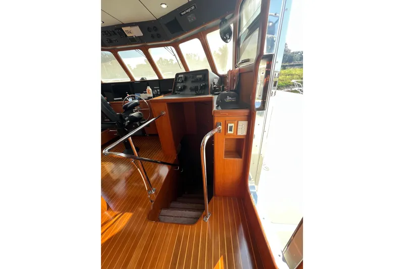 Slide: The Image of Pilothouse interior of 2002 Nordhavn 50 yacht with wooden flooring and control panel. - 9