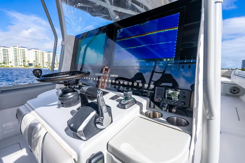 Slide: The Image of Helm of 2021 Contender 44 CB boat with advanced navigation system and controls. - 35
