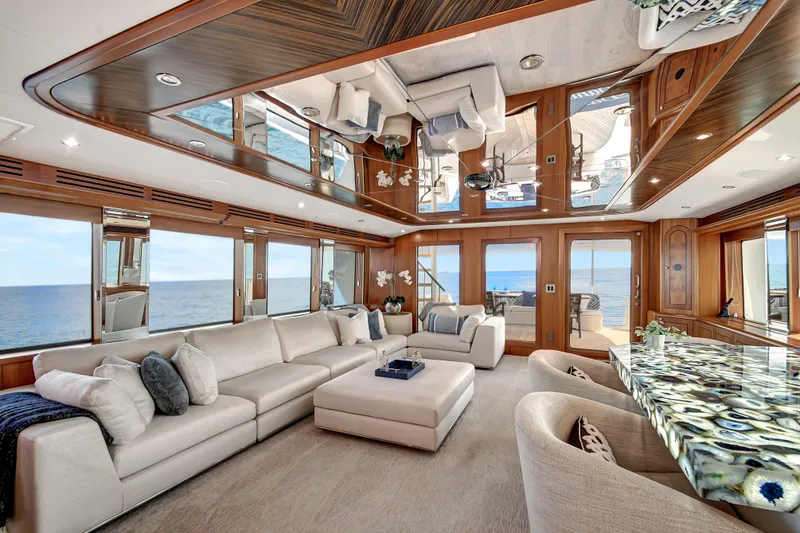 Slide: The Image of Luxurious interior of 2005 Hatteras 100 Motor Yacht with elegant seating and ocean views. - 10