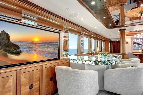 Slide: The Image of Luxurious interior of 2005 Hatteras 100 Motor Yacht with elegant seating and ocean view. - 13