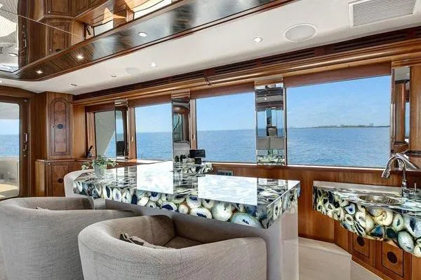 Slide: The Image of Luxurious interior of 2005 Hatteras 100 Motor Yacht with ocean view and elegant decor. - 14