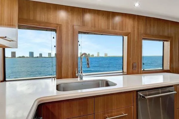Slide: The Image of Luxurious kitchen view from 2005 Hatteras 100 Motor Yacht, featuring ocean and skyline. - 18