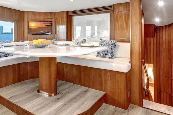 Slide: The Image of Luxurious dining area in 2005 Hatteras 100 Motor Yacht with elegant wood finish. - 19