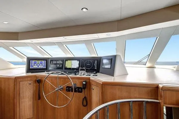 Slide: The Image of Helm of 2005 Hatteras 100 Motor Yacht with navigation displays and steering wheel. - 22