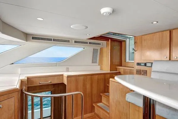 Slide: The Image of Interior of 2005 Hatteras 100 Motor Yacht with wooden cabinetry and ocean view. - 23