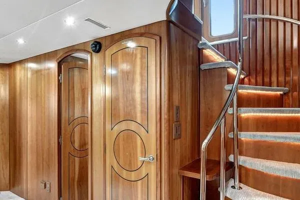 Slide: The Image of Luxurious wooden interior of 2005 Hatteras 100 Motor Yacht with elegant staircase. - 25