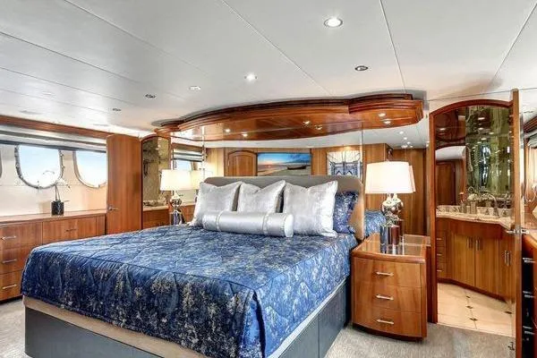 Slide: The Image of Luxurious bedroom interior of 2005 Hatteras 100 Motor Yacht with elegant wood finishes. - 26