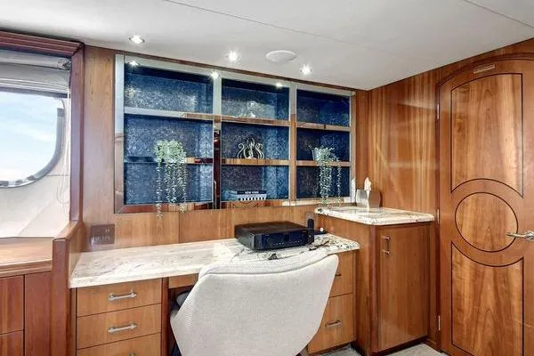 Slide: The Image of Luxurious interior of 2005 Hatteras 100 Motor Yacht with elegant wood cabinetry and desk. - 28