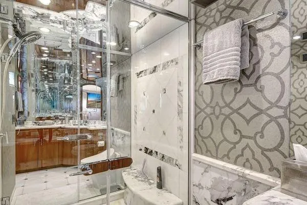 Slide: The Image of Luxurious bathroom with marble accents in a 2005 Hatteras 100 Motor Yacht. - 29