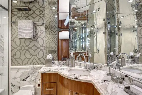Slide: The Image of Luxurious bathroom in 2005 Hatteras 100 Motor Yacht with marble countertops and elegant fixtures. - 30