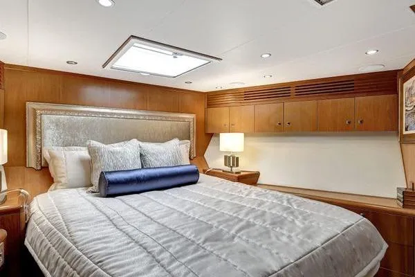 Slide: The Image of Luxurious bedroom interior of 2005 Hatteras 100 Motor Yacht with elegant bedding and wood accents. - 31