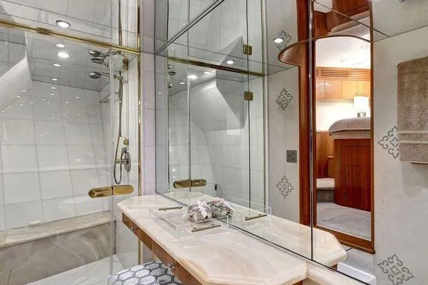 Slide: The Image of Luxurious bathroom in 2005 Hatteras 100 Motor Yacht with elegant fixtures and mirrored walls. - 33
