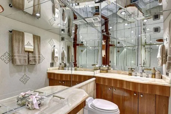 Slide: The Image of Luxurious bathroom in 2005 Hatteras 100 Motor Yacht with mirrored walls and elegant fixtures. - 34