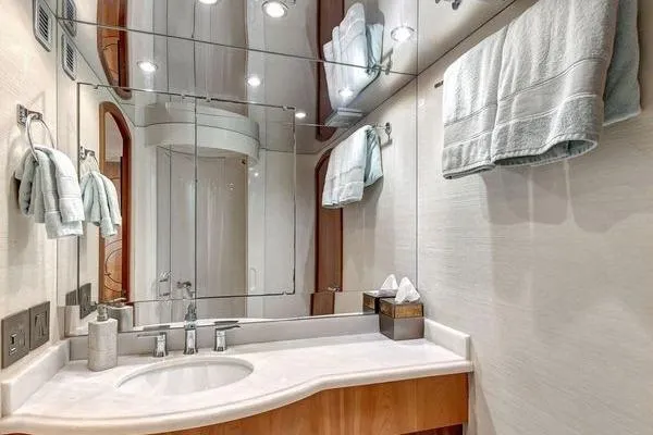 Slide: The Image of Luxurious bathroom in 2005 Hatteras 100 Motor Yacht with elegant fixtures and mirrored walls. - 36