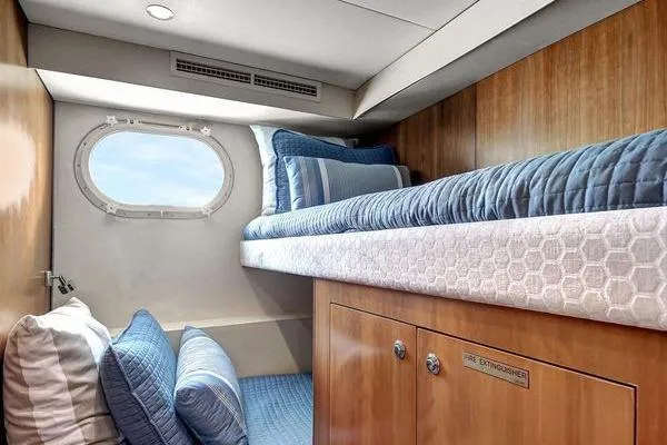 Slide: The Image of Cozy cabin interior of 2005 Hatteras 100 Motor Yacht with blue bedding and porthole window. - 39