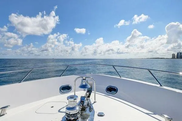 Slide: The Image of Bow view of 2005 Hatteras 100 Motor Yacht on open sea under blue sky. - 42