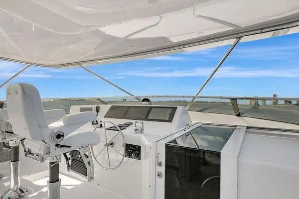 Slide: The Image of Helm of 2005 Hatteras 100 Motor Yacht with ocean view and modern controls. - 43