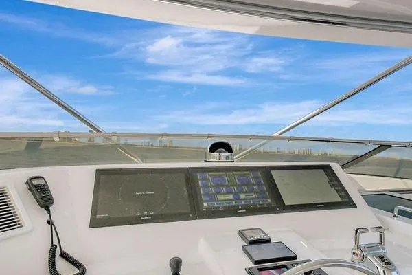 Slide: The Image of Helm of 2005 Hatteras 100 Motor Yacht with navigation equipment and ocean view. - 44