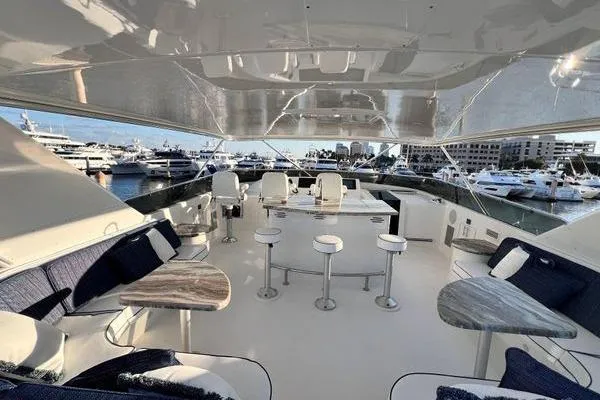Slide: The Image of Luxurious 2005 Hatteras 100 Motor Yacht interior with elegant seating and marina view. - 46