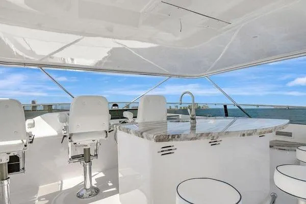 Slide: The Image of Luxurious 2005 Hatteras 100 Motor Yacht with elegant outdoor seating and ocean view. - 48
