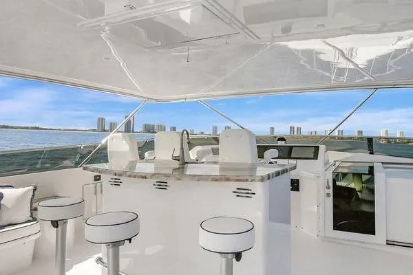 Slide: The Image of Luxurious 2005 Hatteras 100 Motor Yacht interior with modern seating and ocean view. - 49