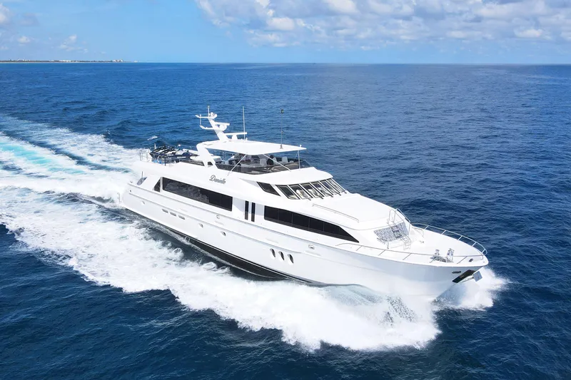 The Image of 2005 Hatteras 100 Motor Yacht cruising on open sea under clear skies. - 5
