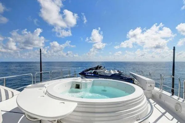 Slide: The Image of Luxurious 2005 Hatteras 100 Motor Yacht with jacuzzi and jet ski on deck. - 52