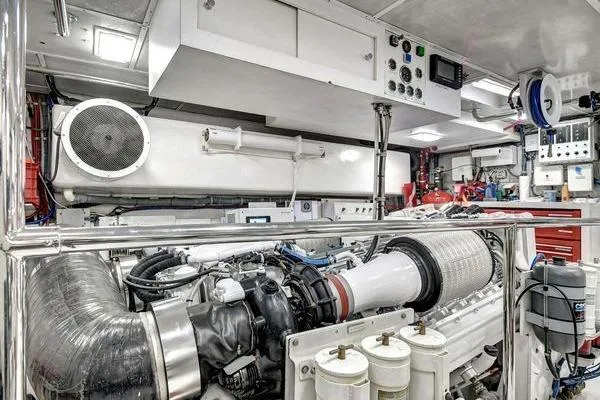 Slide: The Image of Engine room of a 2005 Hatteras 100 Motor Yacht, showcasing advanced machinery and controls. - 55