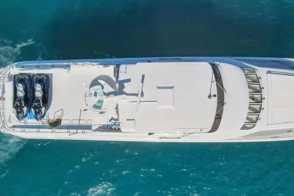 Slide: The Image of Aerial view of 2005 Hatteras 100 Motor Yacht cruising on blue ocean waters. - 58