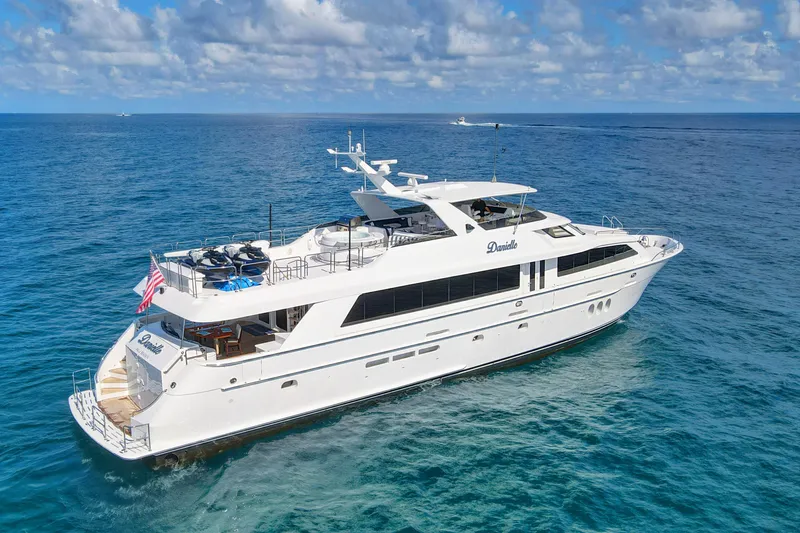 Slide: The Image of 2005 Hatteras 100 Motor Yacht cruising on open sea under blue sky. - 7