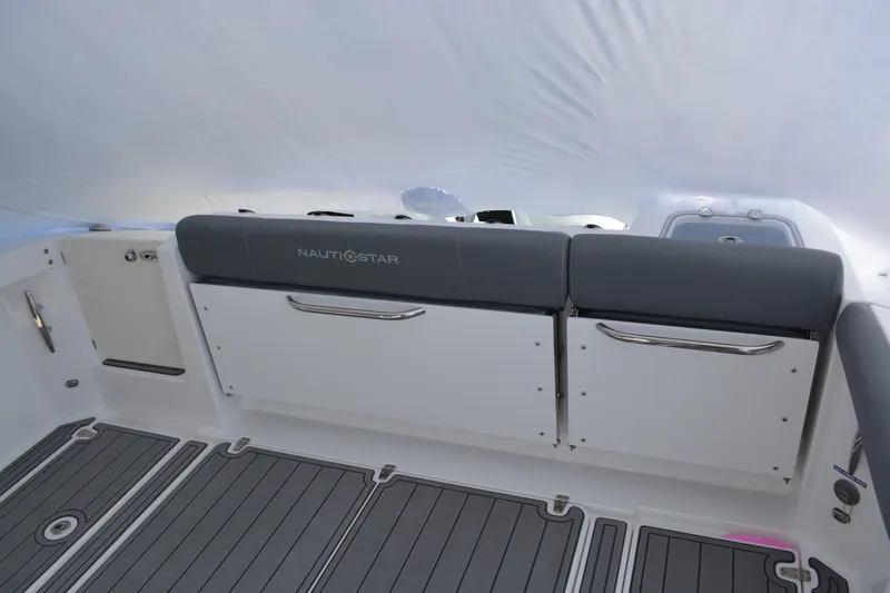 Slide: The Image of 2026 NauticStar 332 Offshore boat interior with gray seating and cup holders. - 19