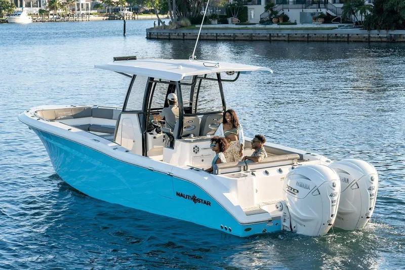 Slide: The Image of 2026 NauticStar 332 Offshore boat in a showroom, featuring sleek design and modern amenities. - 2