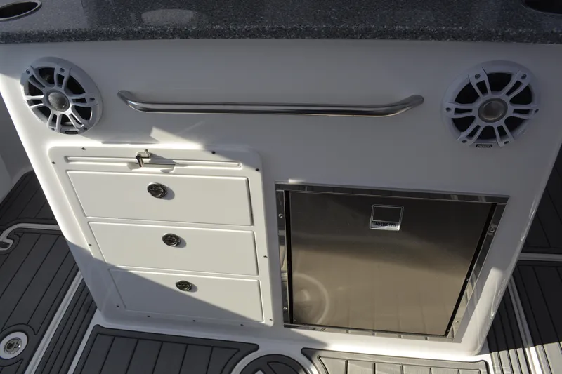 Slide: The Image of 2026 NauticStar 332 Offshore boat interior with cup holders and seating. - 21