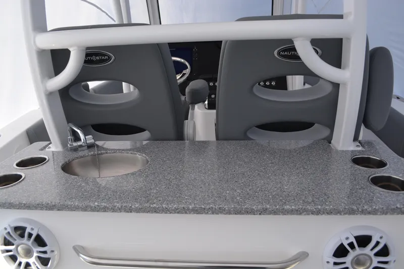 Slide: The Image of 2026 NauticStar 332 Offshore boat interior with gray seating and storage compartments. - 22