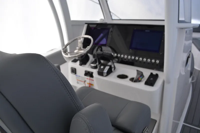 Slide: The Image of 2026 NauticStar 332 Offshore boat interior with seating and cup holders. - 27