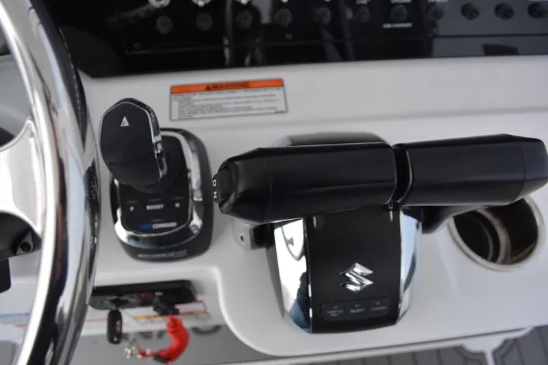 Slide: The Image of Interior view of 2026 NauticStar 332 Offshore boat cockpit with compass and navigation screens. - 29