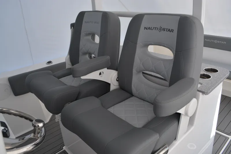 Slide: The Image of Close-up of 2026 NauticStar 332 Offshore boat controls and steering wheel. - 32