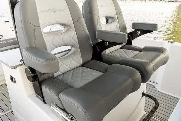 Slide: The Image of 2026 NauticStar 332 Offshore boat with dual Suzuki engines in showroom. - 5