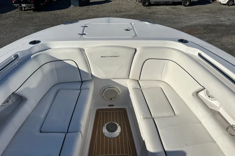 Slide: The Image of 2020 Southport 33DC boat interior with white seating and teak flooring. - 15