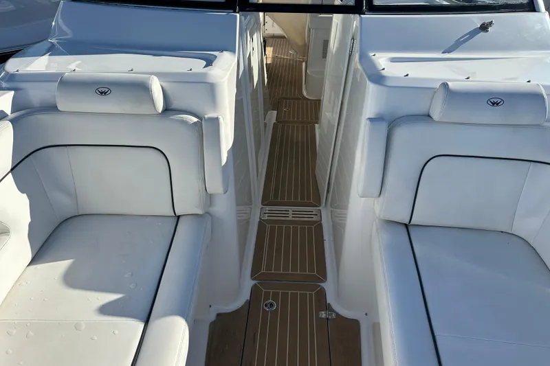 Slide: The Image of 2020 Southport 33DC boat interior with white seating and wooden flooring. - 18