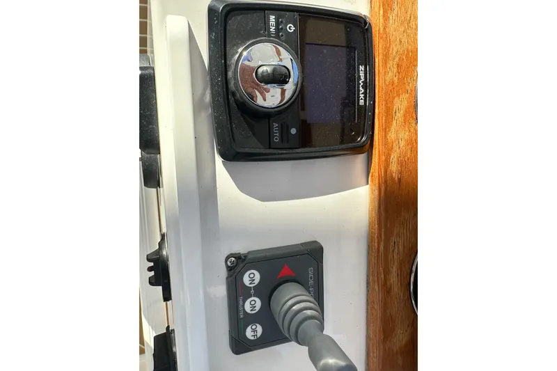 Slide: The Image of Control panel of a 2020 Southport 33DC boat featuring Zipwake and thruster controls. - 22