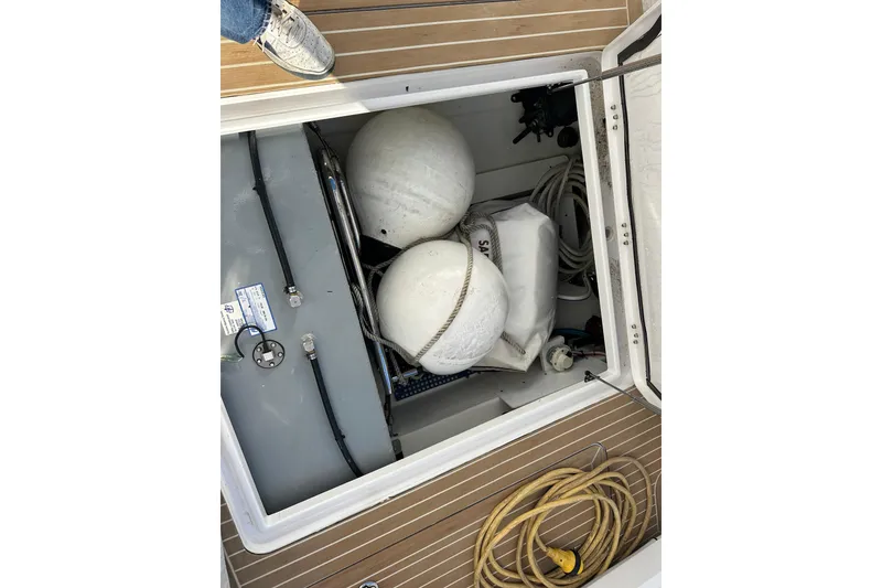 Slide: The Image of 2020 Southport 33DC boat storage compartment with fenders and ropes. - 27