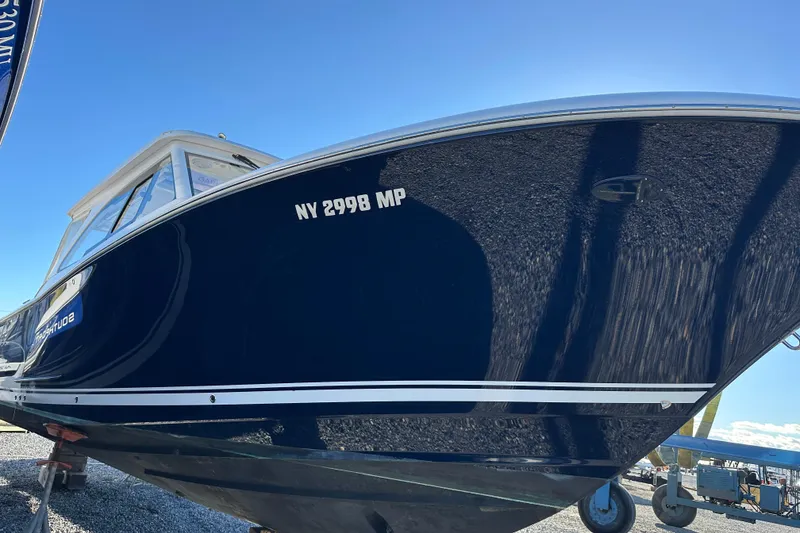 Slide: The Image of 2020 Southport 33DC boat with NY registration, docked under clear blue sky. - 3